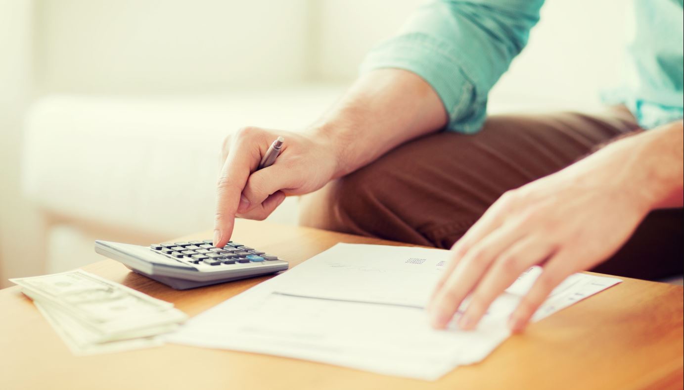 Man Using Calculator Franchise Cost